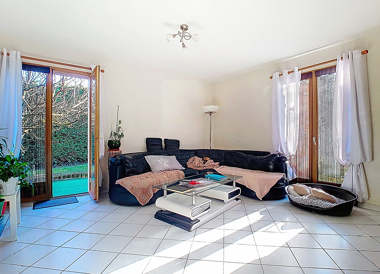 Spacious property in Haute-Savoie featuring a bright living area with garden access and natural light.