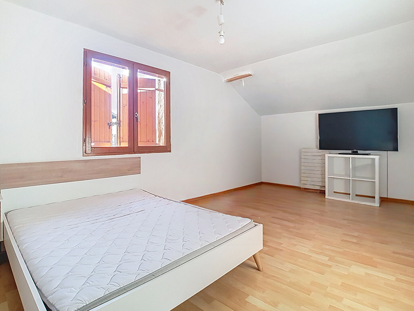 Spacious bedroom in a property located in Haute-Savoie, Auvergne-Rhône-Alpes, featuring wooden flooring and natural light.