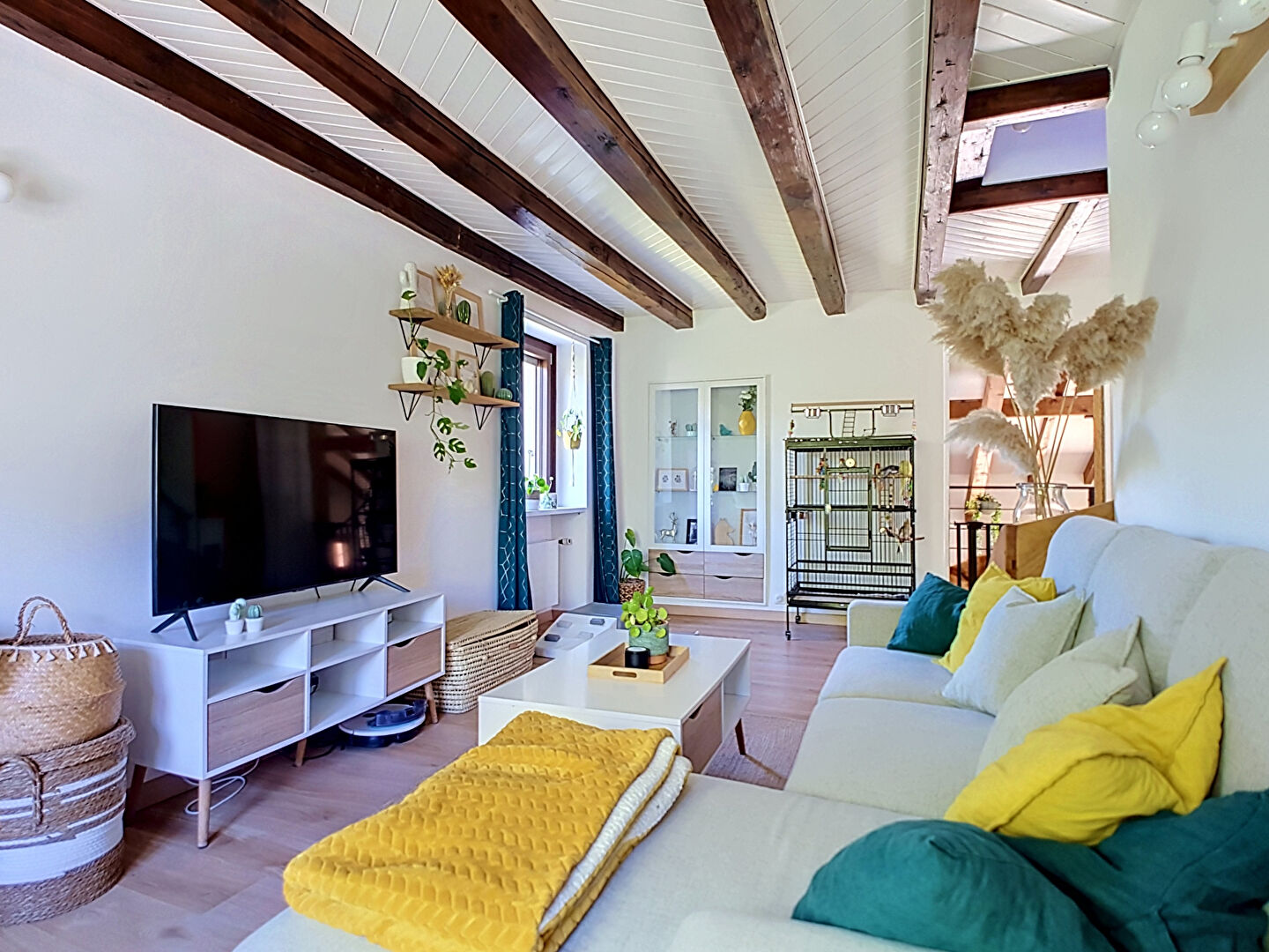 Modern property in Haute-Savoie featuring an open-plan kitchen, dining area, and wooden beams.