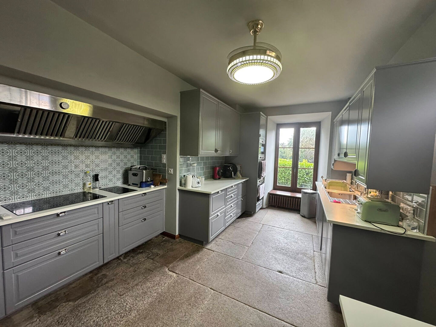 Modern kitchen features grey cabinetry and natural light in Haute-Vienne, Nouvelle-Aquitaine, with 10 bedrooms property.