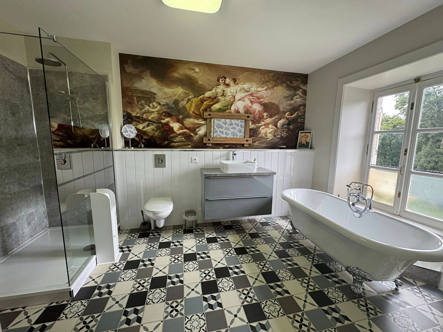 Spacious property in Haute-Vienne featuring a stylish bathroom with a freestanding bath and modern fixtures.