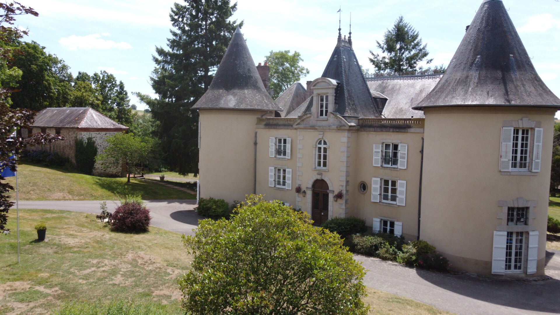 Château in Haute-Vienne, Nouvelle-Aquitaine, featuring turreted architecture and landscaped gardens.