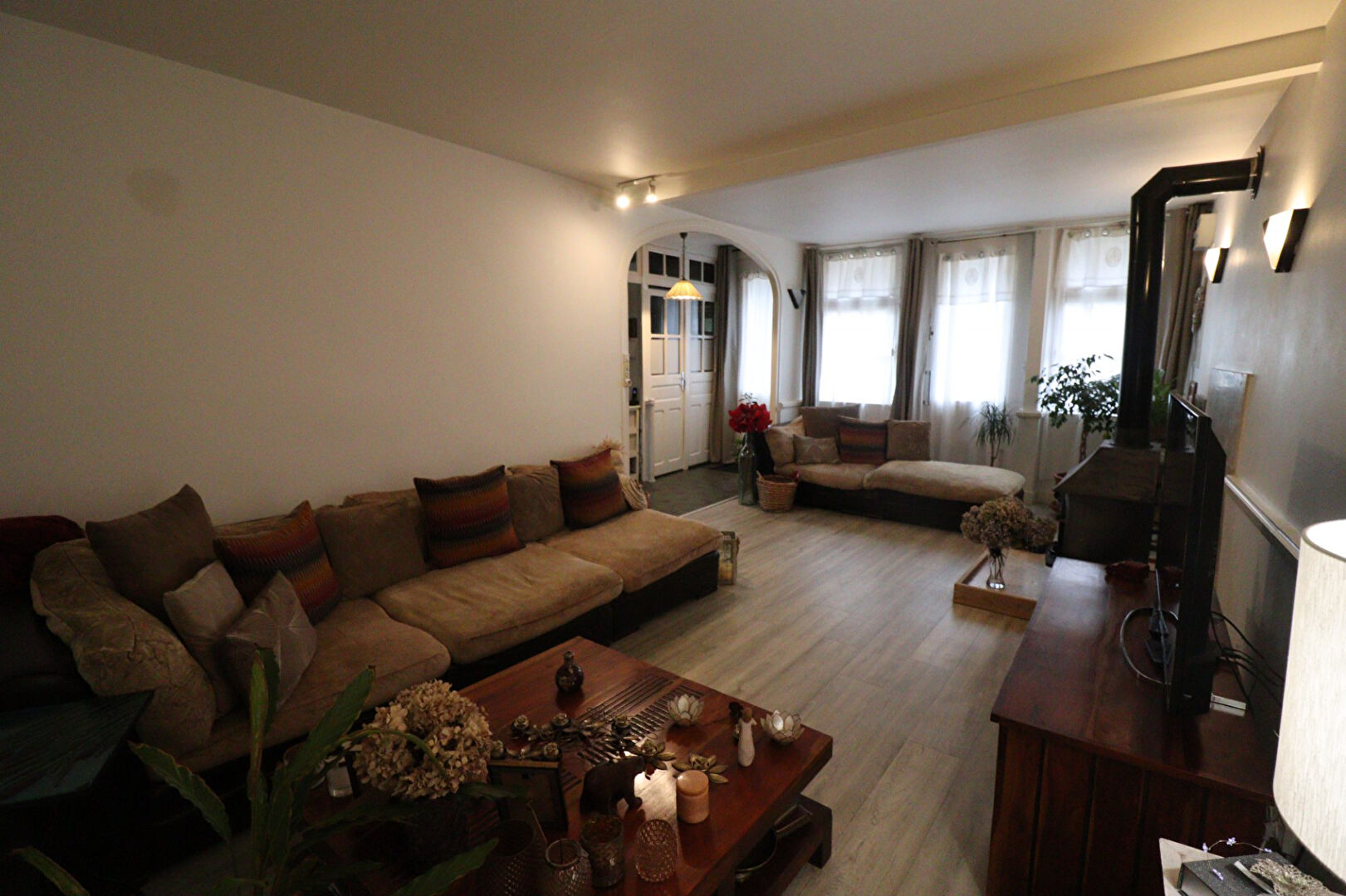 Spacious living room in a property located in Corrèze, Nouvelle-Aquitaine, featuring ample seating and natural light.