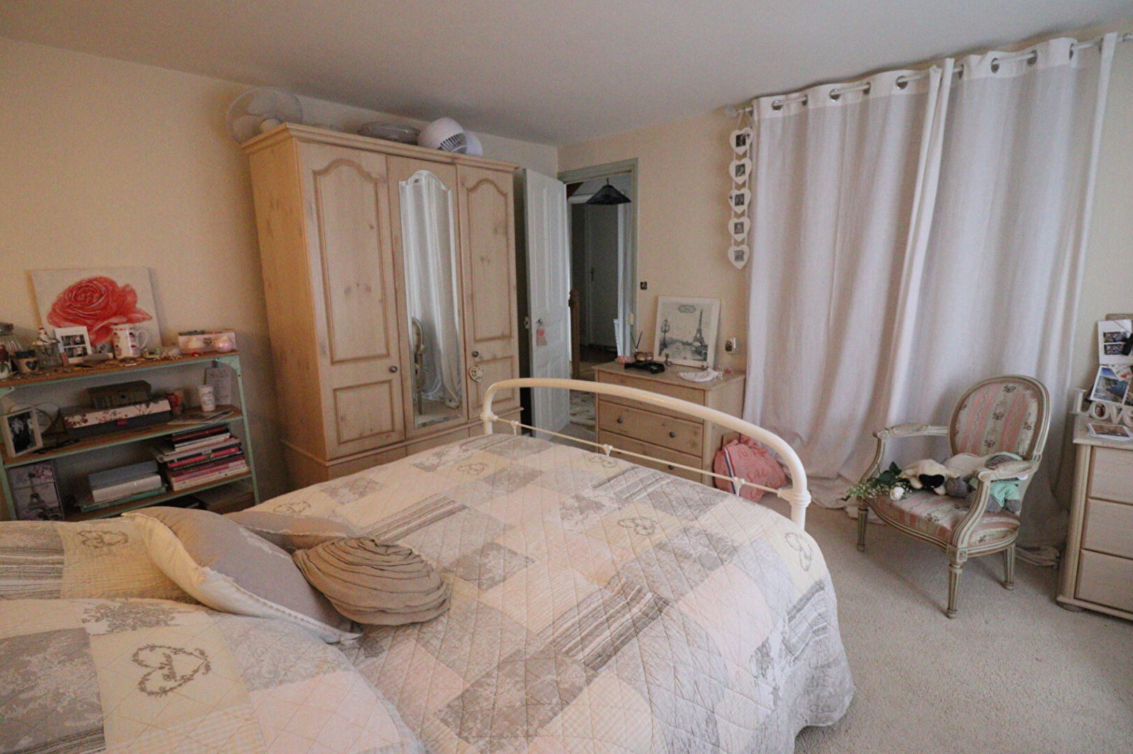 Spacious bedroom with a double bed and wardrobe in a property located in Corrèze, Nouvelle-Aquitaine.