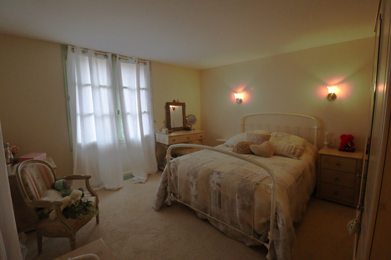 Five-bedroom property in Corrèze, Nouvelle-Aquitaine, featuring a bright bedroom with natural light and soft décor.