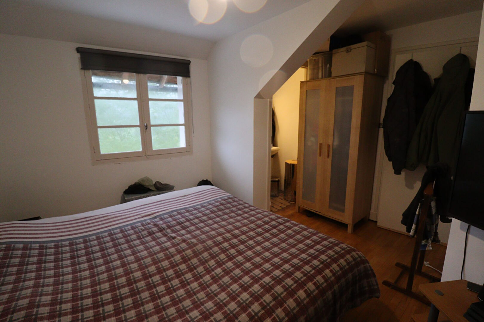 Five-bedroom property in Corrèze with a cosy interior, featuring a bed, wardrobe, and natural light from windows.