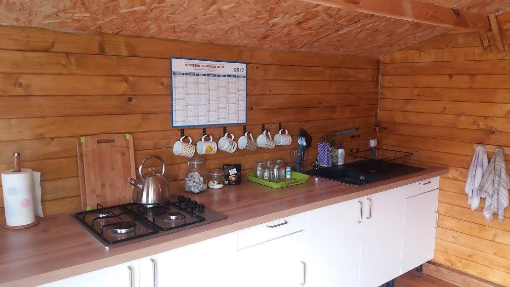 Kitchen in a property located in Haute-Vienne, Nouvelle-Aquitaine, featuring wooden walls and modern appliances.