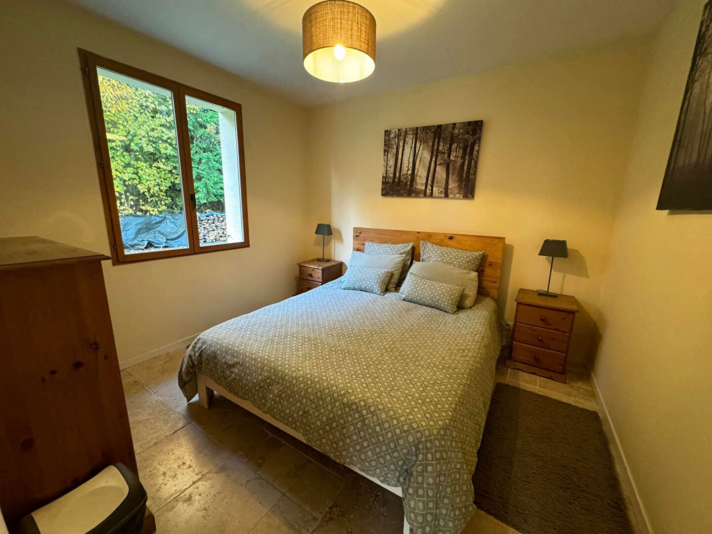 Three-bedroom property in Haute-Vienne with natural light from large windows and a warm, inviting interior.