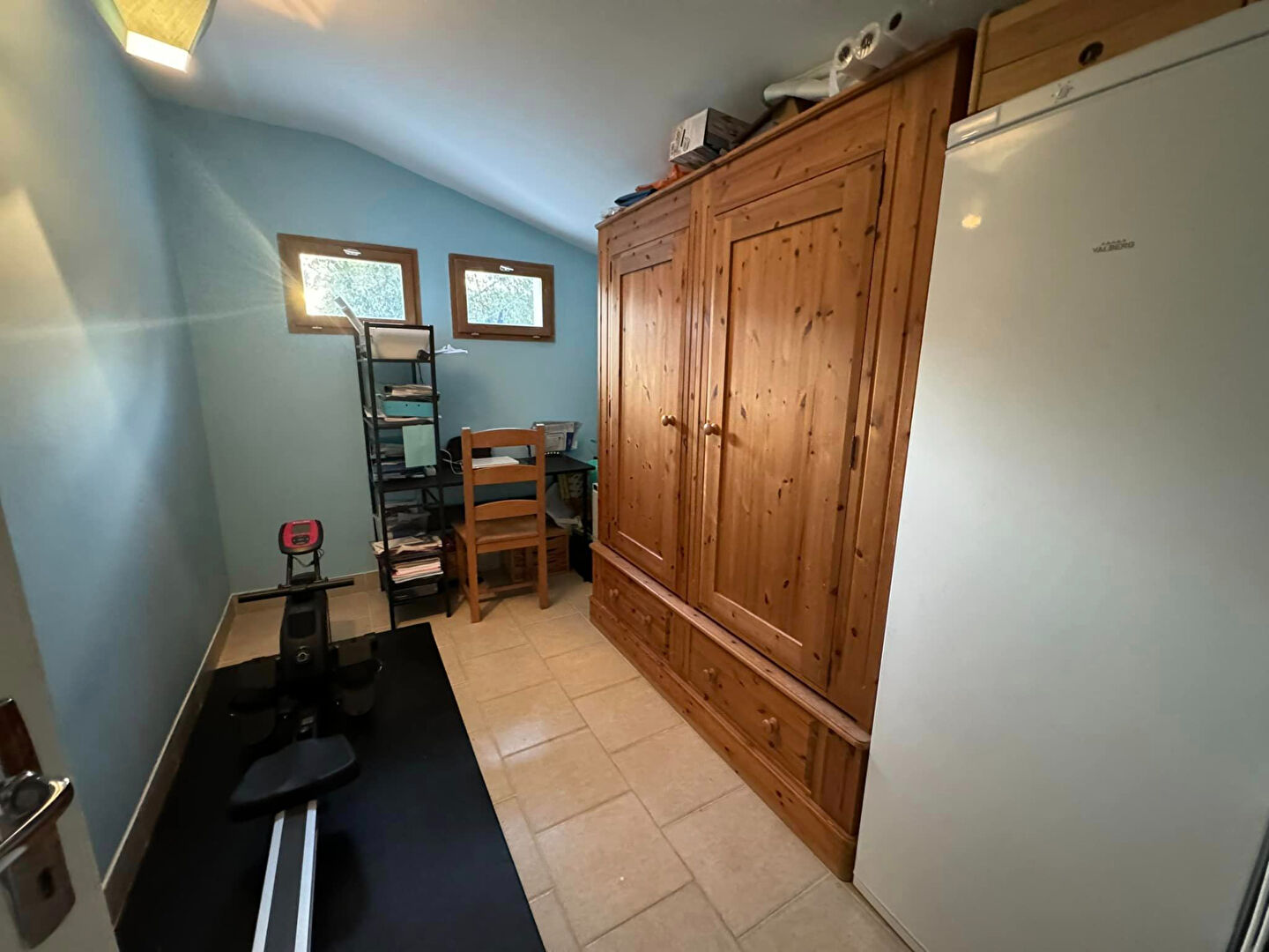 Spacious property in Haute-Vienne with a wooden storage unit and exercise area, featuring ample natural light.
