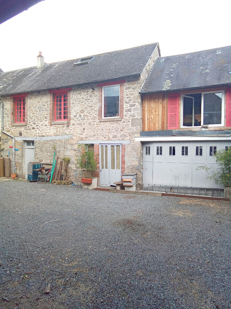 Spacious property in Creuse, Nouvelle-Aquitaine, featuring stone exterior and garage with gravel driveway.