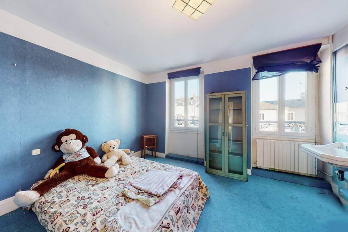 Five-bedroom property in Creuse, Nouvelle-Aquitaine, featuring a spacious room with blue walls and large windows.