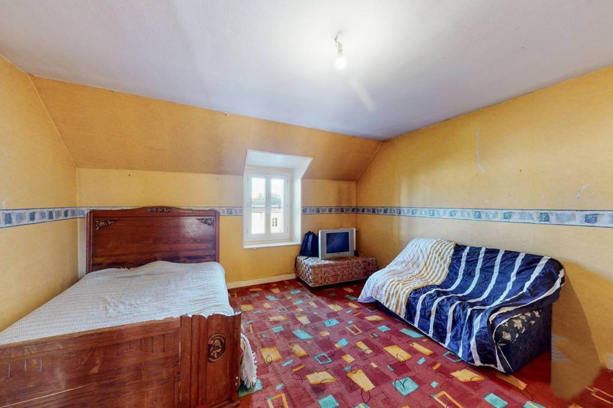 Five-bedroom property in Creuse, Nouvelle-Aquitaine, featuring a bright interior with colourful flooring and window view.