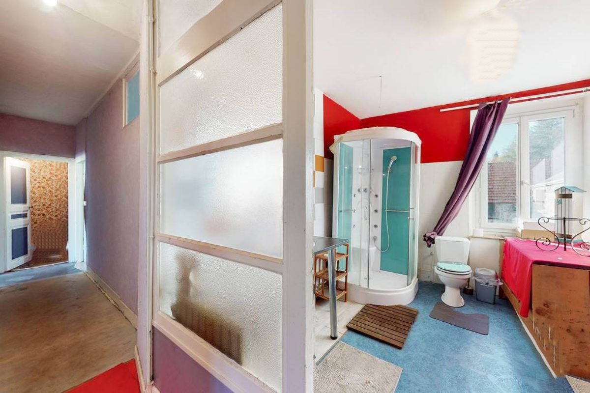 Spacious property in Creuse, Nouvelle-Aquitaine, featuring a bathroom with modern fixtures and vibrant decor.