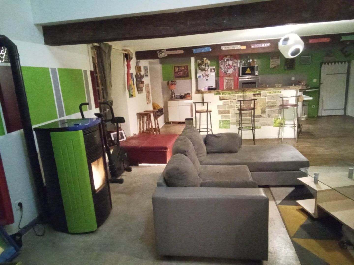 Spacious property in Creuse, Nouvelle-Aquitaine, featuring a modern lounge area with comfortable seating and a kitchen bar.