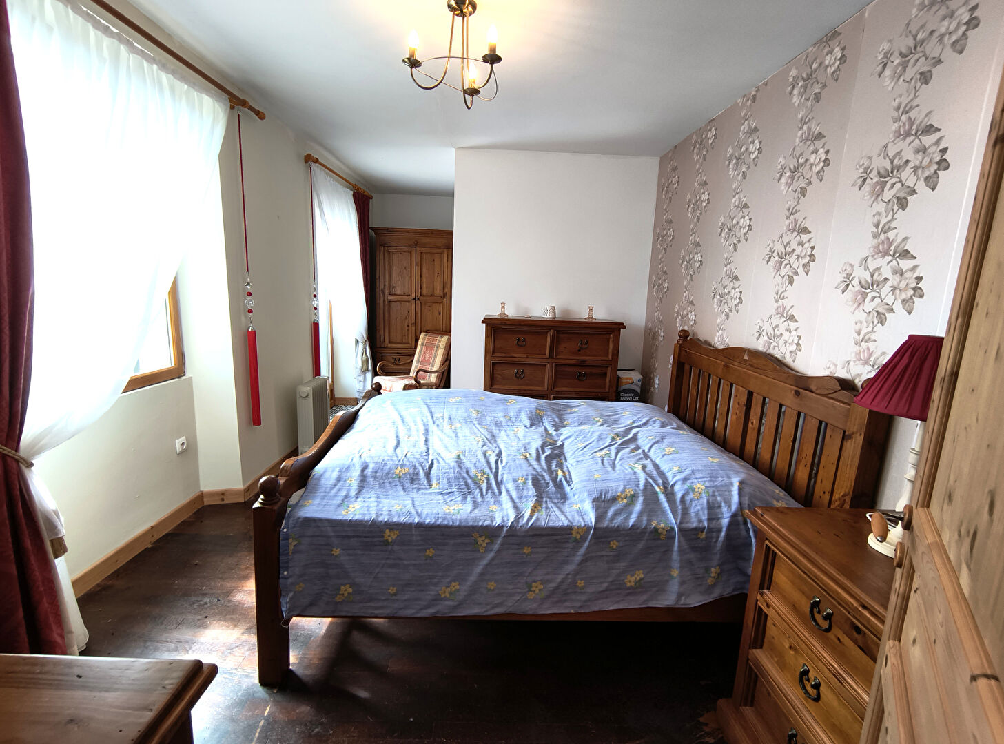 Spacious bedroom featuring wooden furniture in a property located in Creuse, Nouvelle-Aquitaine, 23300, France.