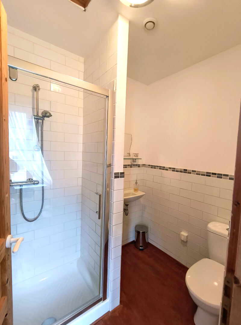 Modern bathroom featuring a shower, sink, and toilet in a property located in Creuse, Nouvelle-Aquitaine.