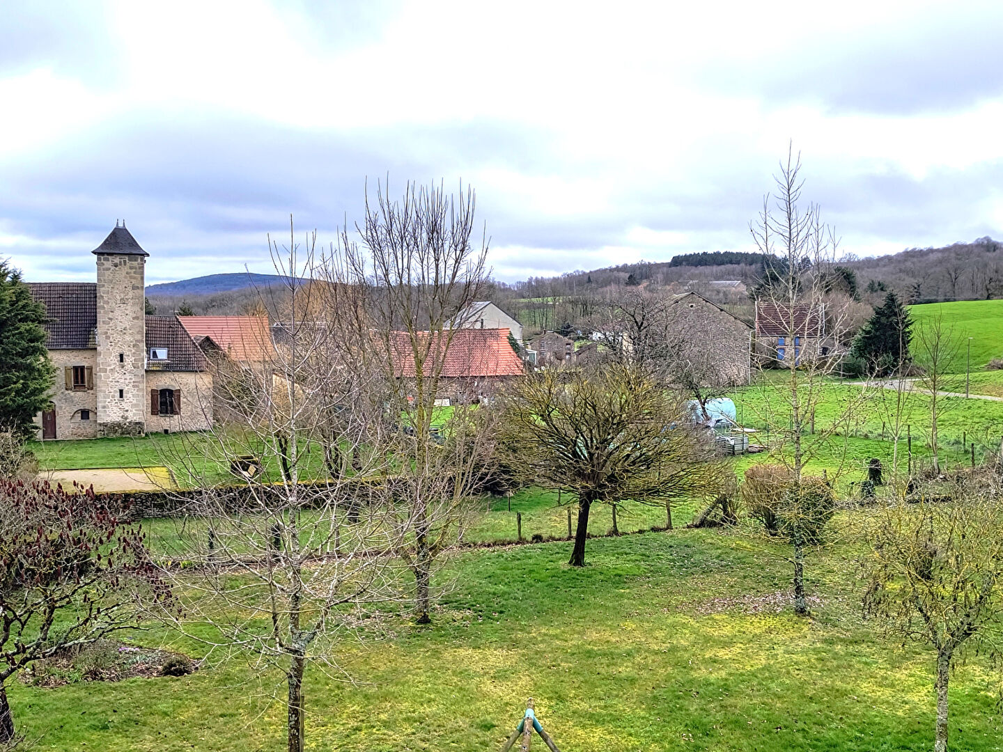 Property in Creuse, Nouvelle-Aquitaine, features a scenic view with greenery and rustic buildings.