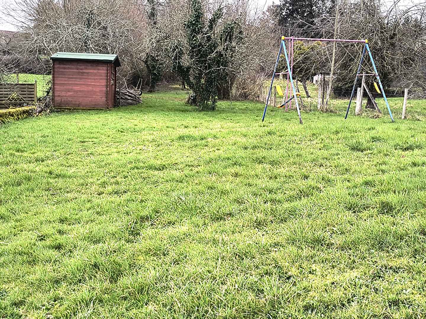 Spacious garden with swing set and shed, located in Creuse, Nouvelle-Aquitaine, featuring a 4-bedroom property.