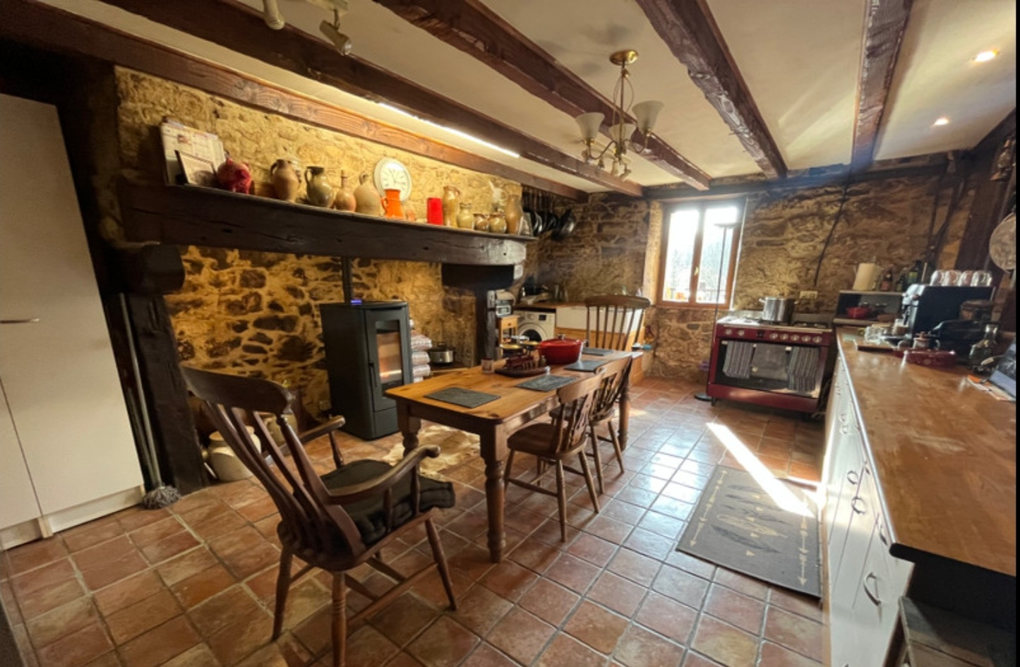 Three-bedroom property in Haute-Vienne featuring a rustic kitchen with exposed beams and stone walls.