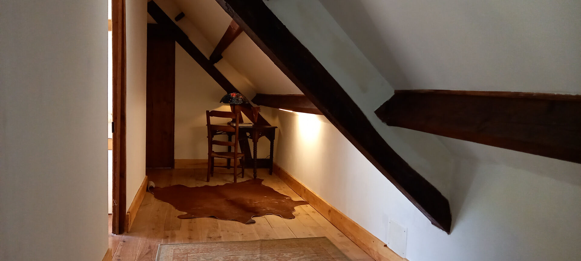 3-bedroom property in Haute-Vienne, Nouvelle-Aquitaine, featuring wooden beams and a cosy hallway with a rustic chair.