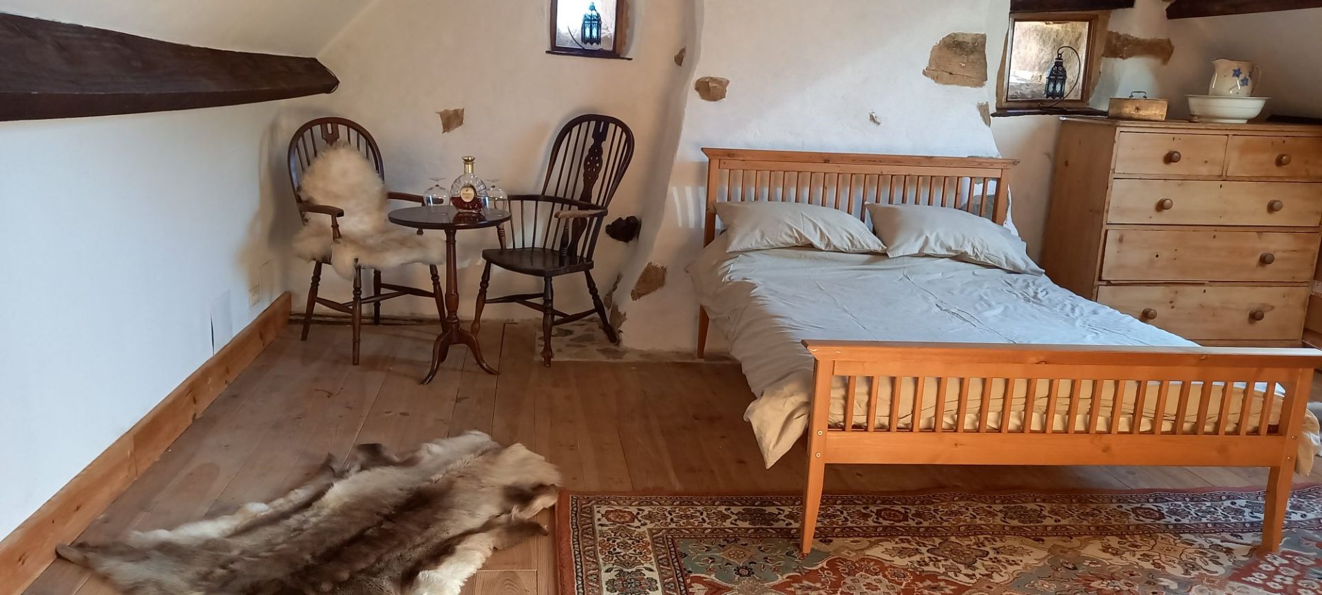 Spacious property in Haute-Vienne with wooden furnishings, a cosy bedroom, and rustic interior charm.
