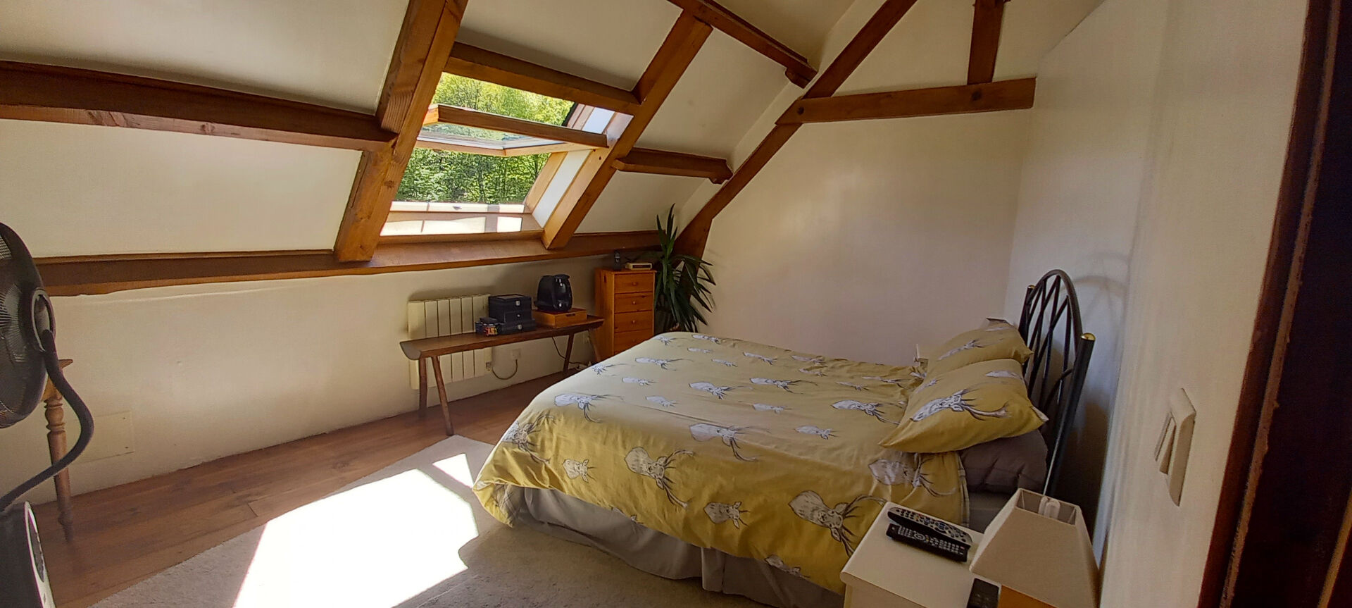 Bright bedroom with wooden beams, featuring a double bed, located in Haute-Vienne, Nouvelle-Aquitaine.