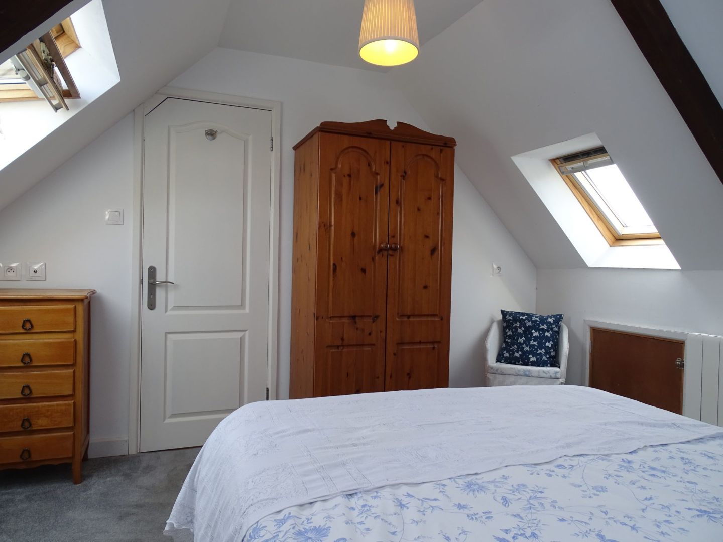 Three-bedroom property in Côtes-d'Armor, Brittany, featuring sloped ceilings and wooden furniture.
