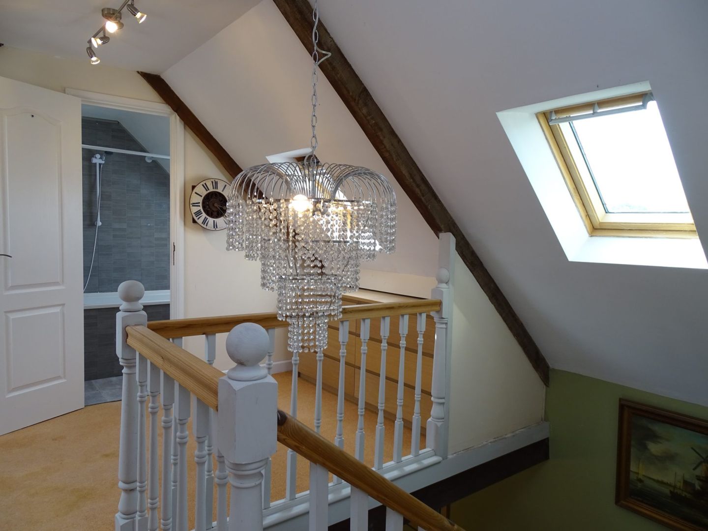 Stylish interior of a property in Côtes-d'Armor, Brittany, featuring a chandelier and sloped ceiling.