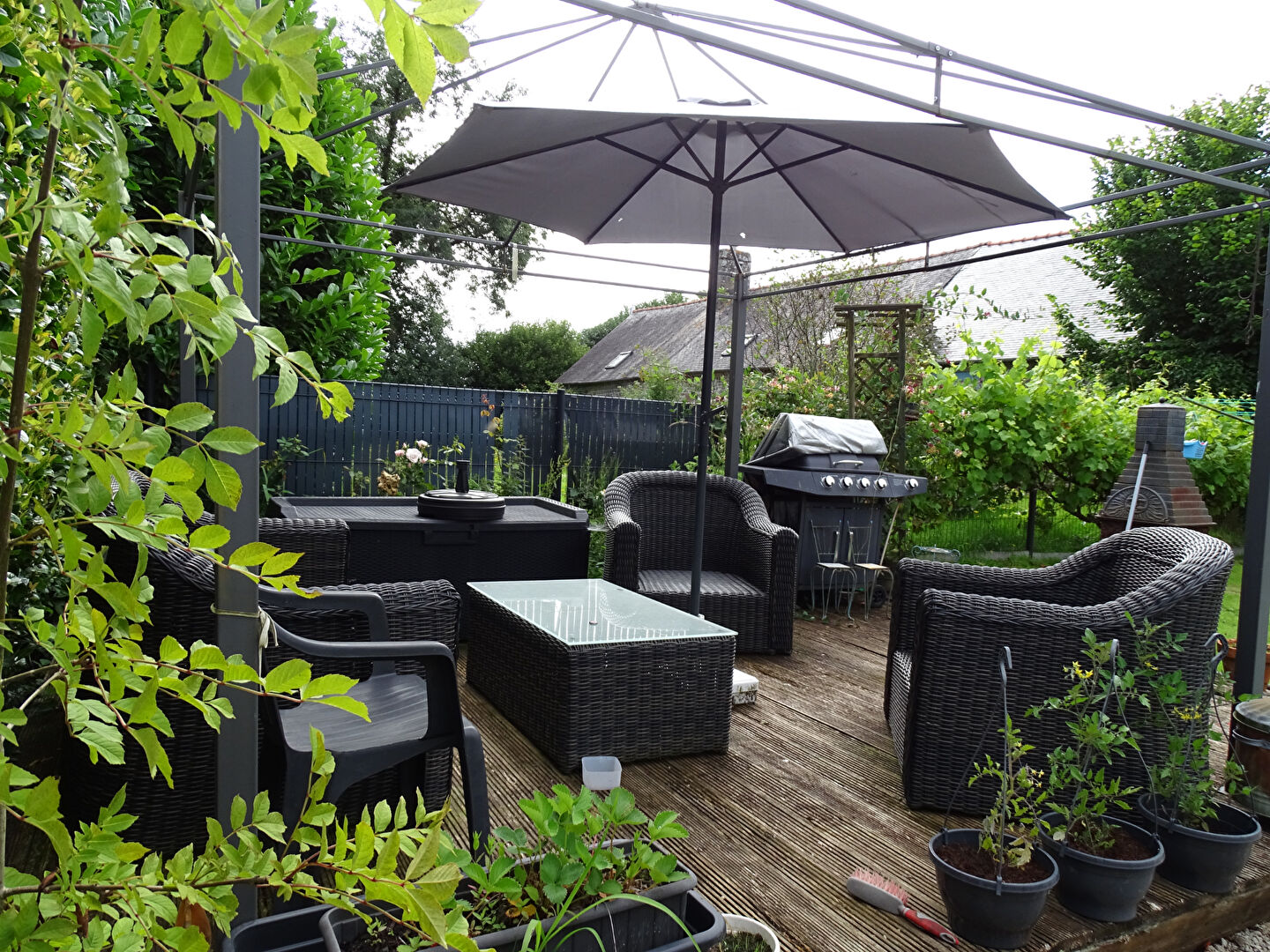 Stylish outdoor seating area with a parasol, located in Côtes-d'Armor, Brittany, featuring three bedrooms.