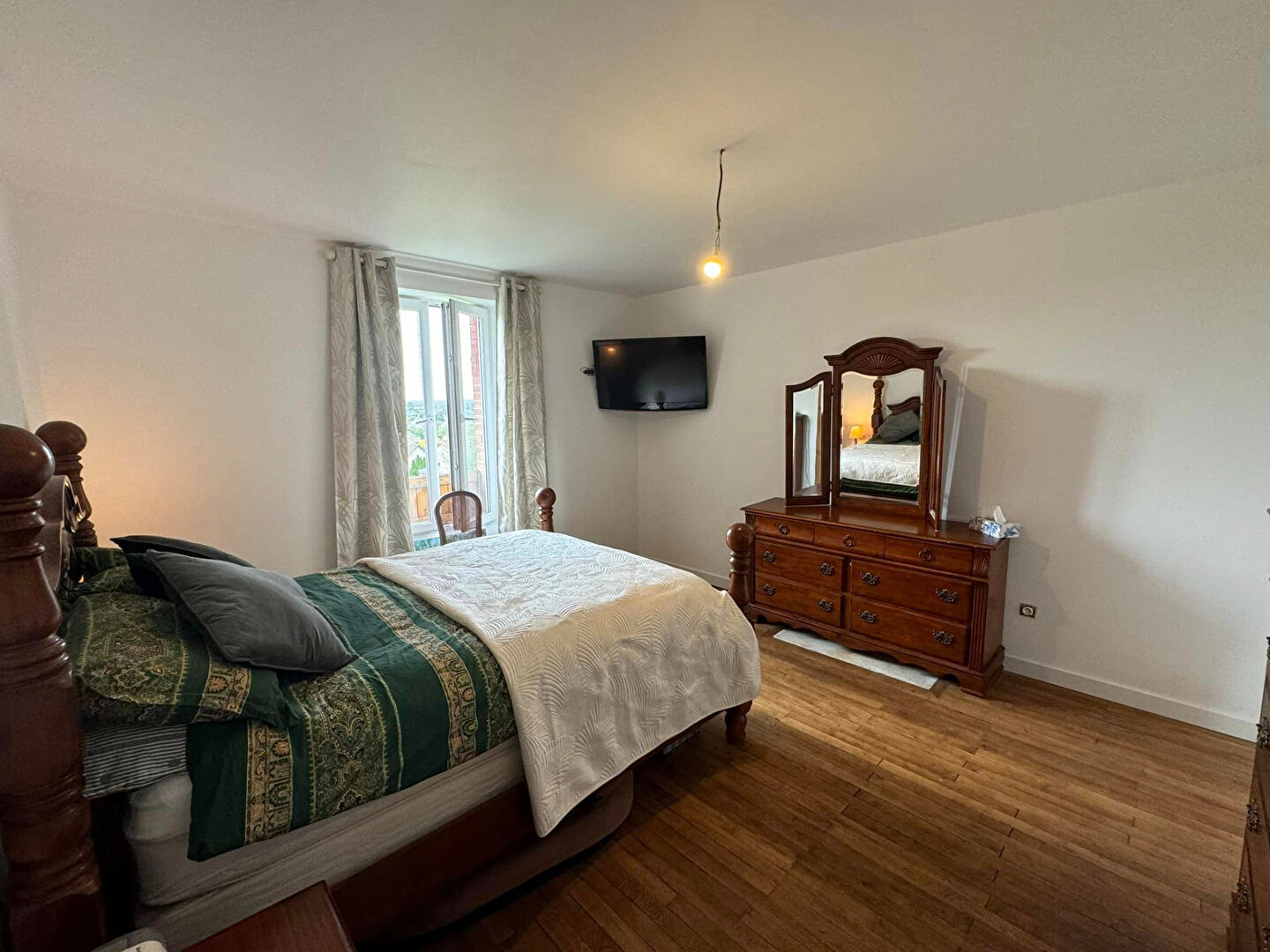 Spacious bedroom in a property located in Haute-Vienne, Nouvelle-Aquitaine, featuring wooden furniture and natural light.