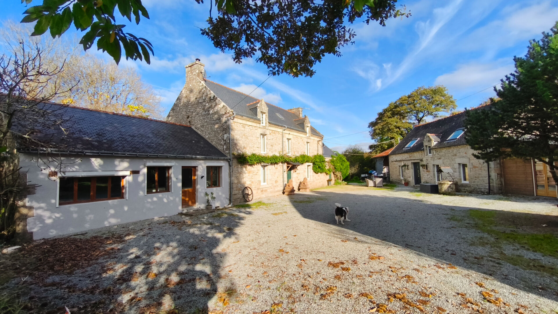 Spacious property in Morbihan, Brittany, featuring a gravel courtyard and traditional stone architecture.