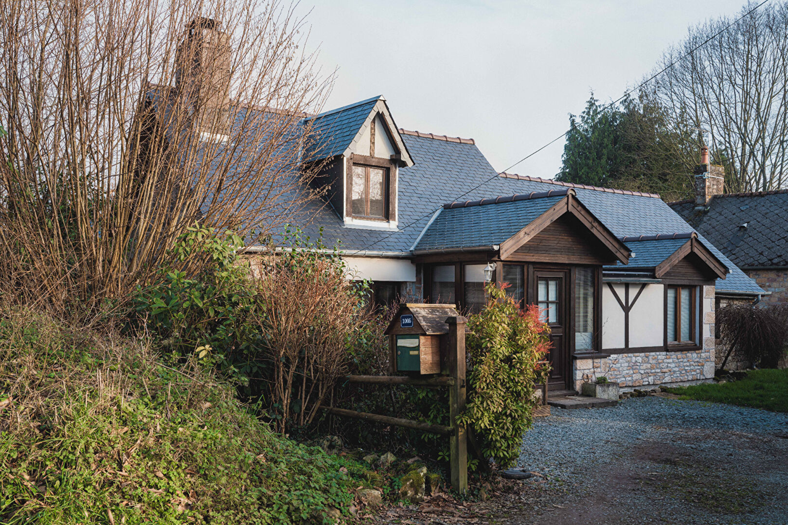 Charming property in Orne, Normandy, featuring a mix of traditional architecture and lush greenery.