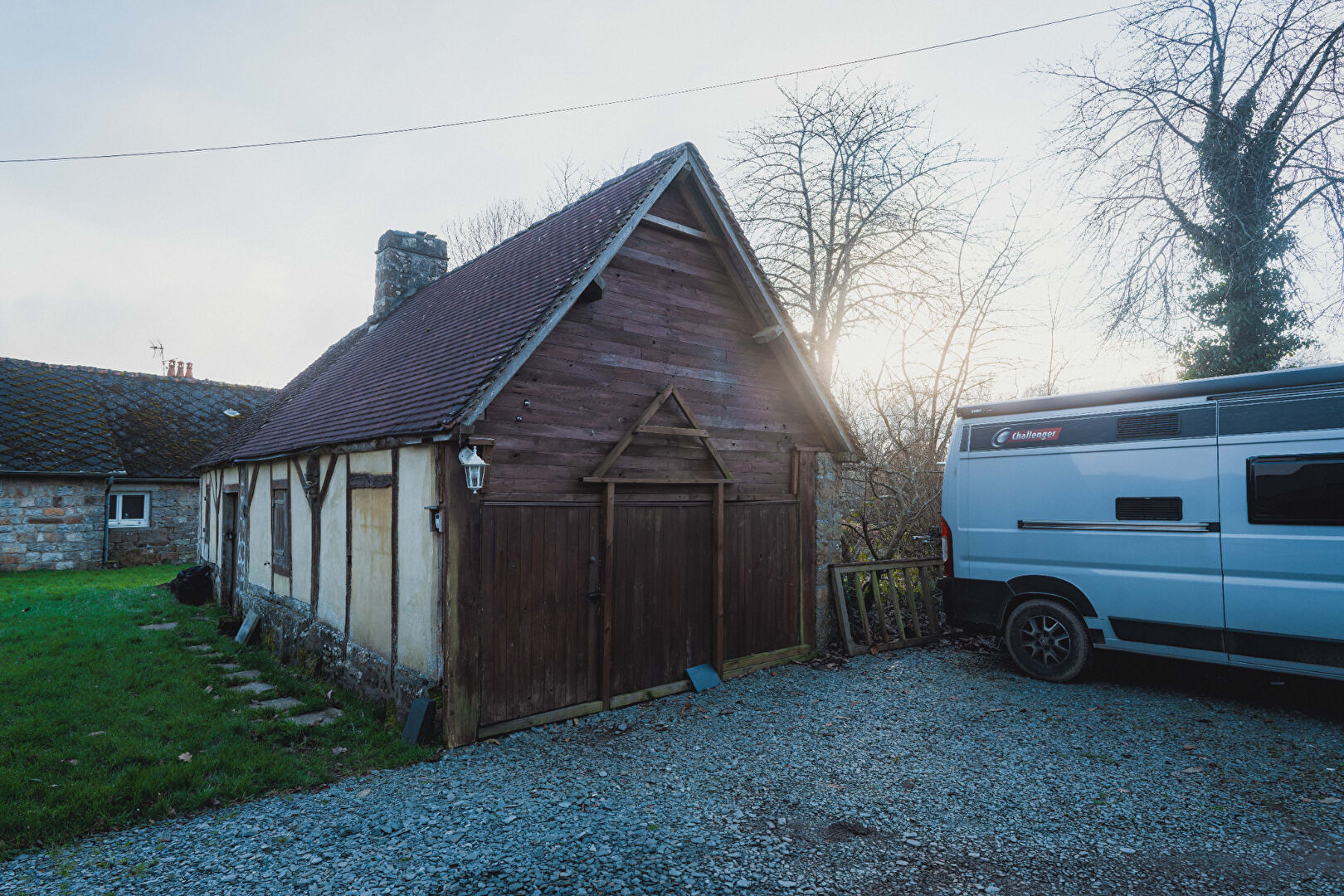 Two-bedroom property in Orne, Normandy, featuring a traditional exterior and gravel drive.