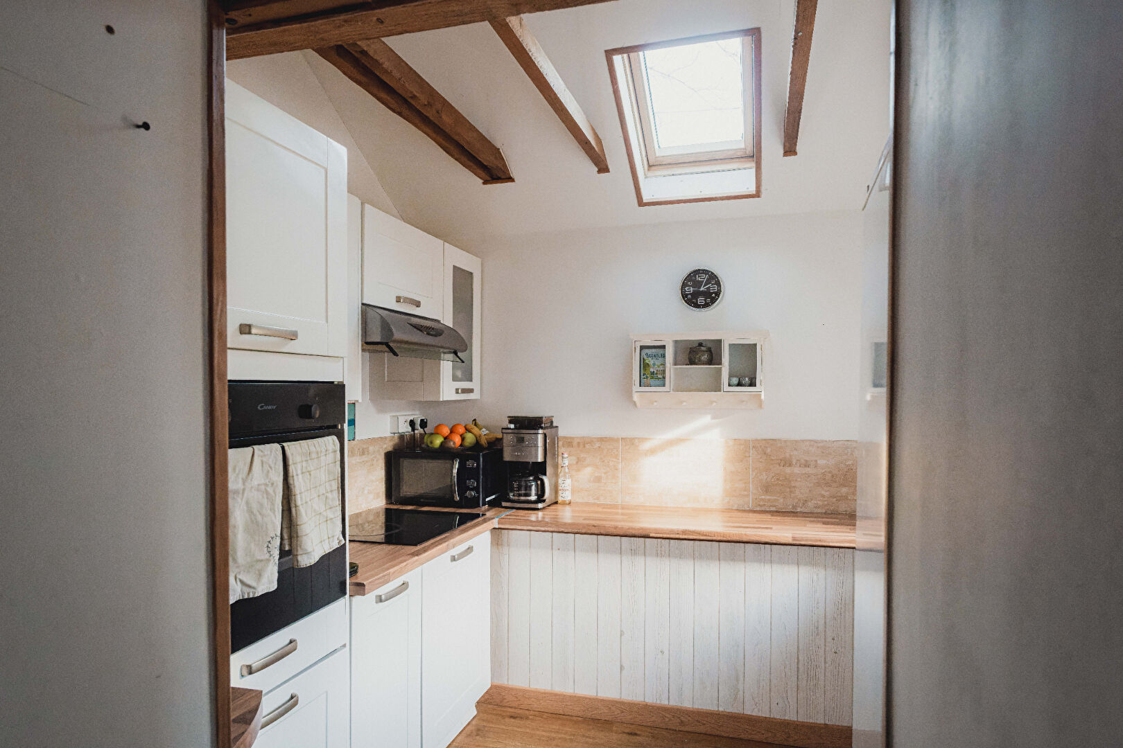 Modern kitchen with skylight and wooden beams in property located in Orne, Normandy, 61700.
