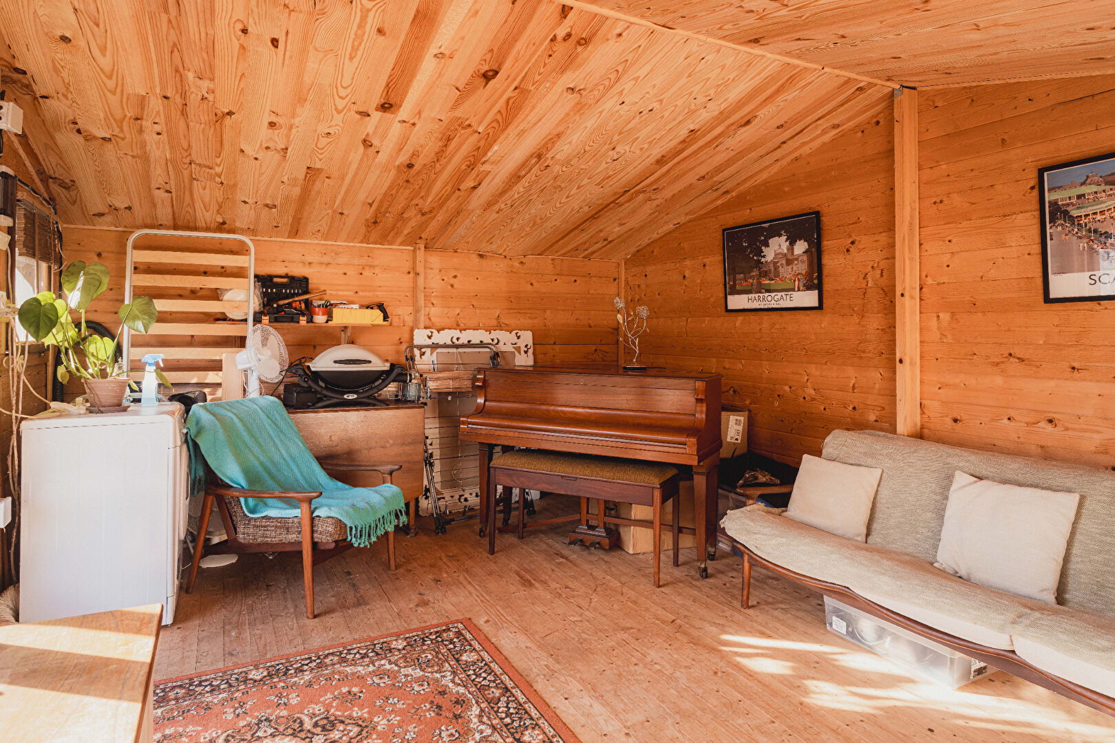 Cosy property in Orne, Normandy, featuring wooden interiors, a piano, and comfortable seating in a bright space.