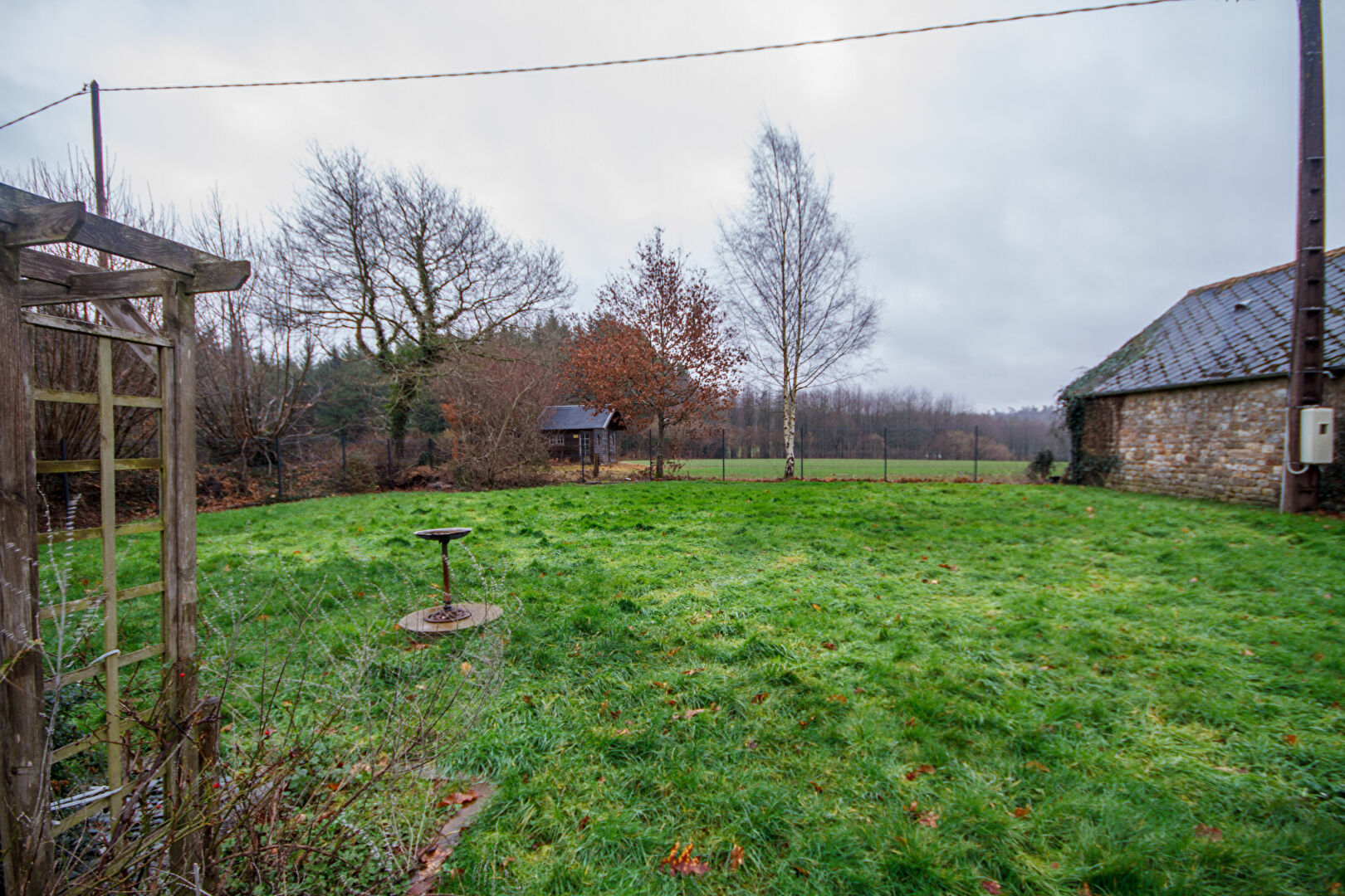 Property with garden in Orne, Normandy, featuring open green space and surrounding trees. Two bedrooms included.