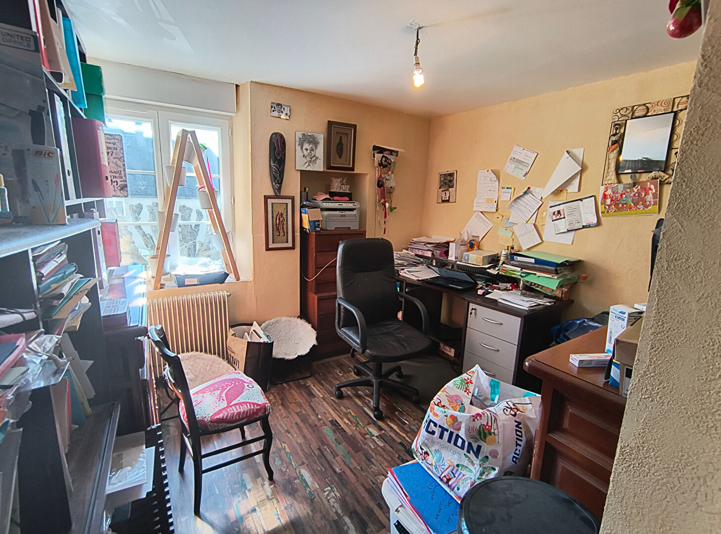 Room in a property with cluttered workspace in Haute-Vienne, Nouvelle-Aquitaine, featuring shelves and desk.