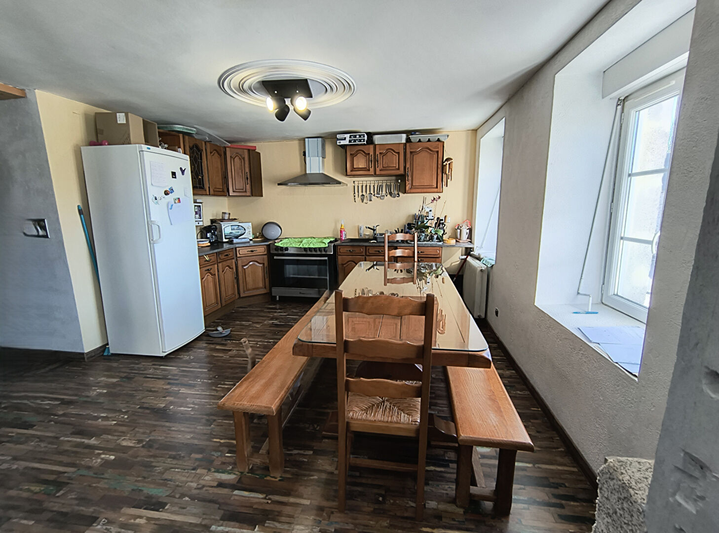 Spacious kitchen with dining area featuring wooden table, in a property located in Haute-Vienne, Nouvelle-Aquitaine.