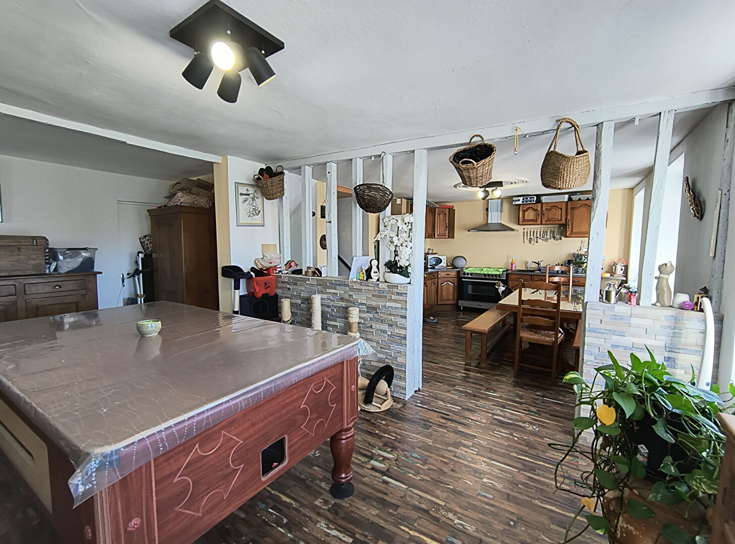 Spacious property in Haute-Vienne featuring a modern kitchen and dining area with wooden flooring and ample storage.