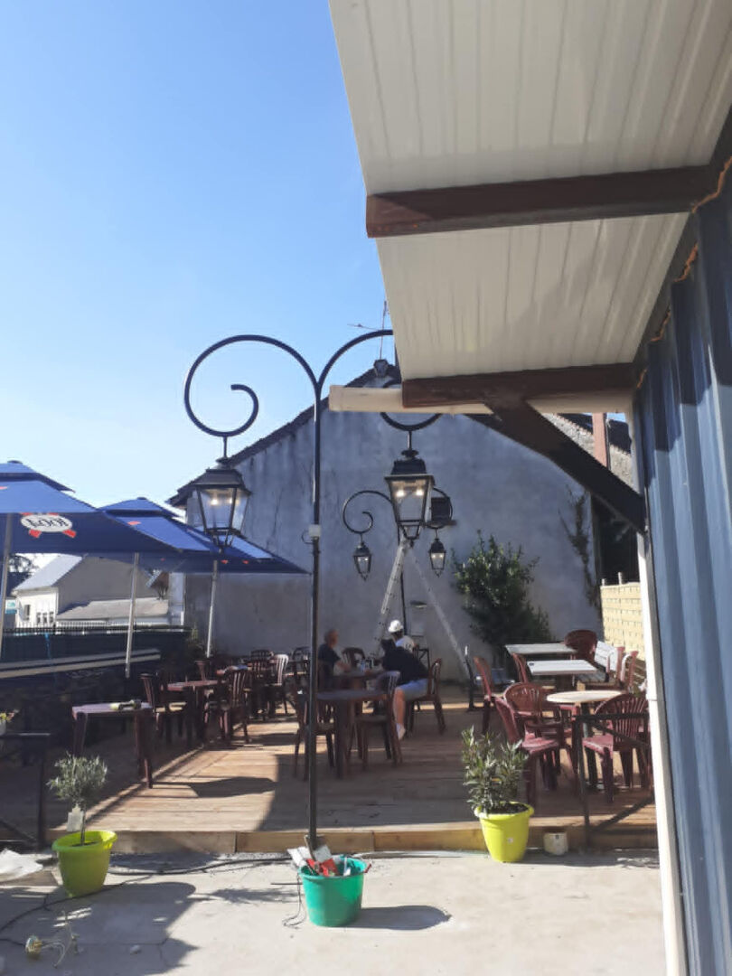 Outdoor seating area with lamps in Haute-Vienne, Nouvelle-Aquitaine; ideal for dining or relaxation at the property.