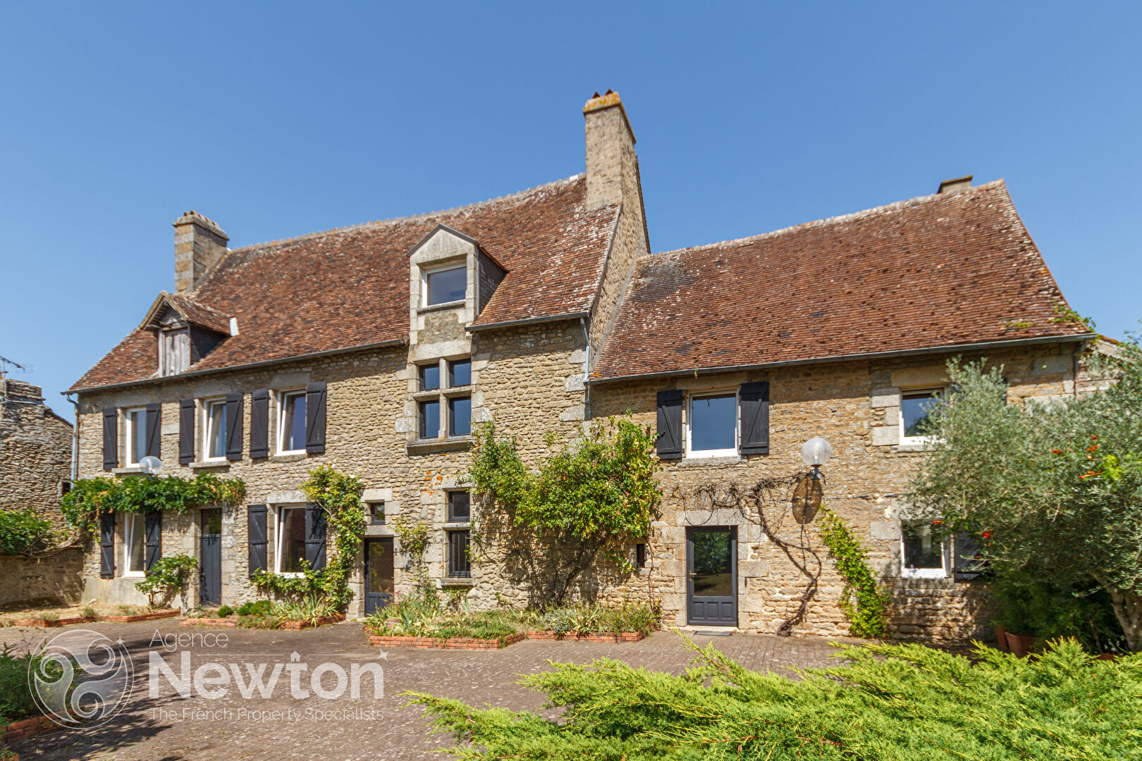 Seven-bedroom property in Orne, Normandy, featuring stone façade and lush garden space.