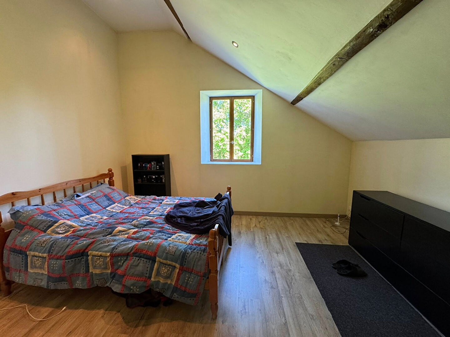 Two-bedroom property in Haute-Vienne, Nouvelle-Aquitaine, featuring a sloped ceiling and a window with garden views.