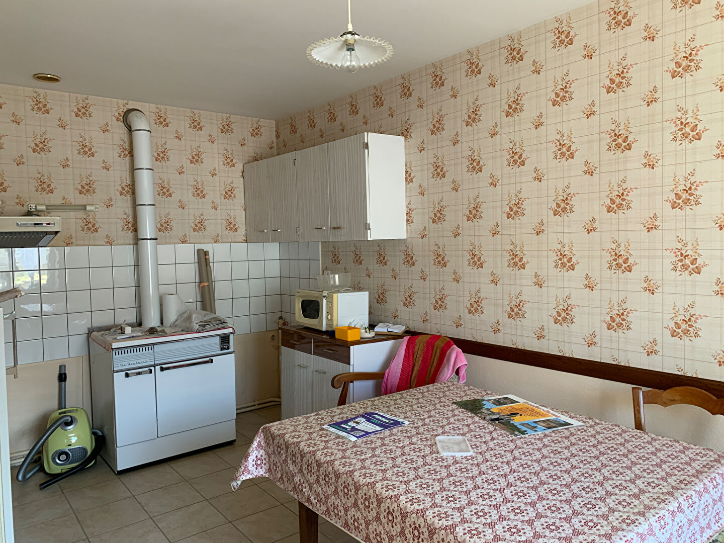 Two-bedroom property in Charente, Nouvelle-Aquitaine, featuring a simple kitchen with a table and essential appliances.