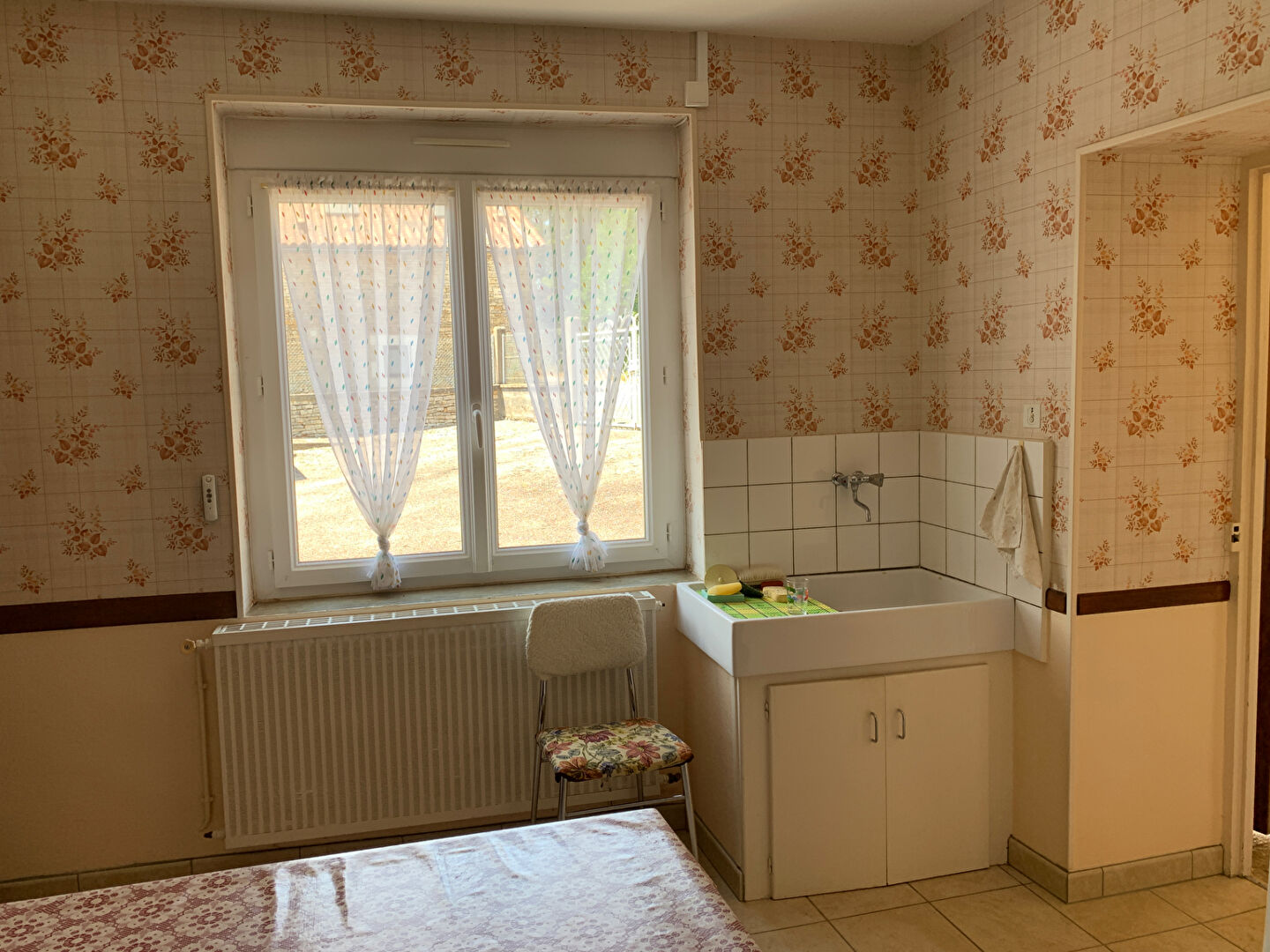 Two-bedroom property in Charente, Nouvelle-Aquitaine, featuring patterned wallpaper and a corner wash area.