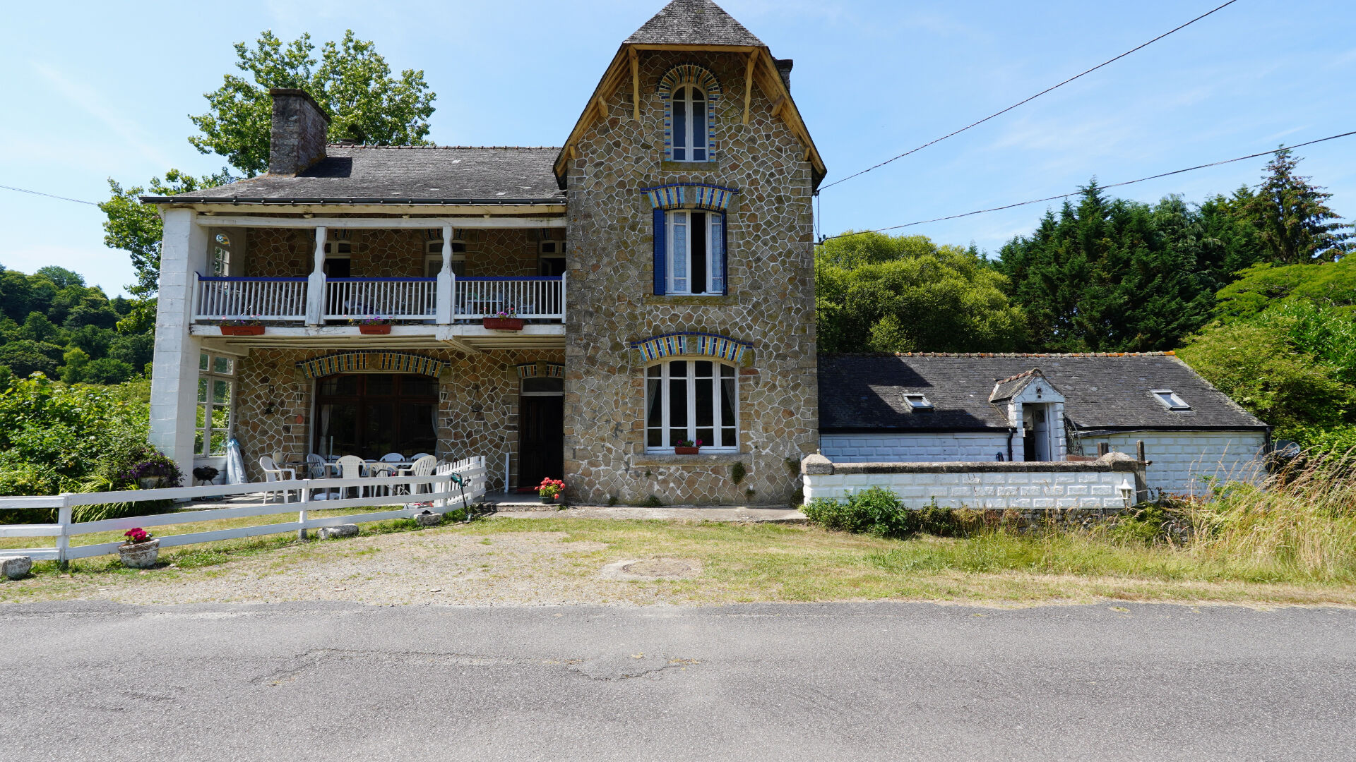 Stone property in Morbihan, Brittany, featuring a tower, large garden, and multiple outdoor seating areas.