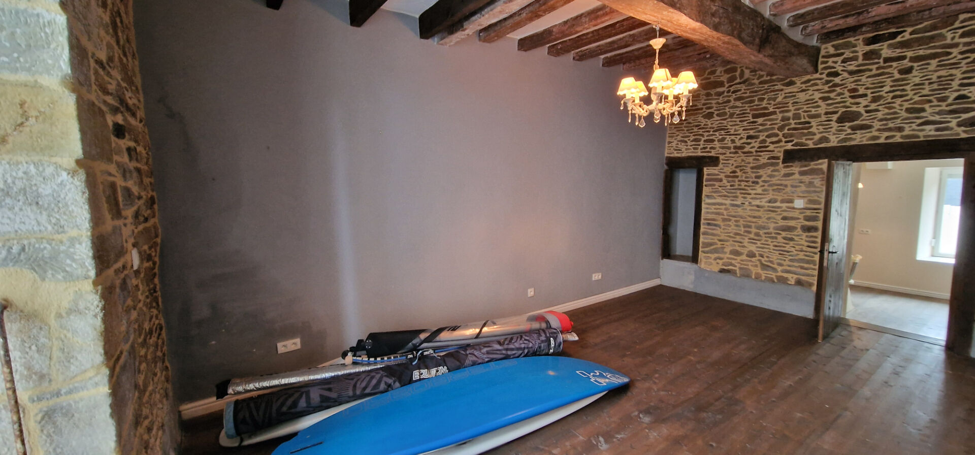 Spacious property in Morbihan, Brittany, featuring wooden beams, stone walls, and ample room for storage.