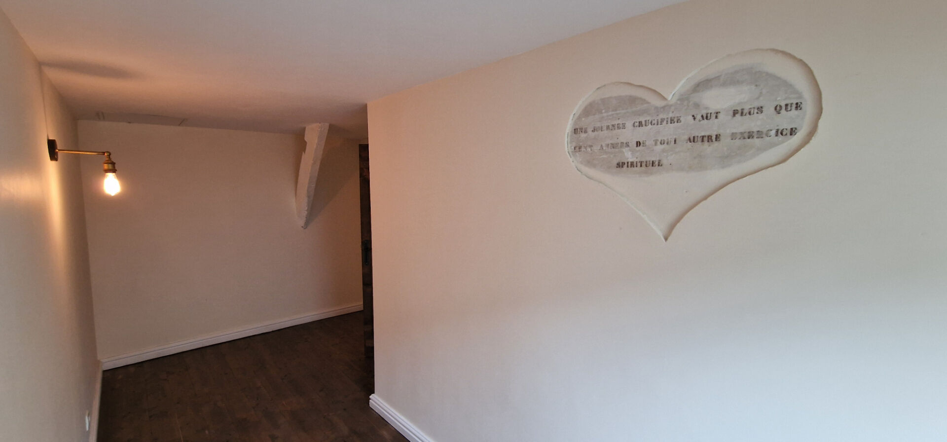 Spacious interior of property in Morbihan, Brittany, featuring unique wall art and warm lighting.