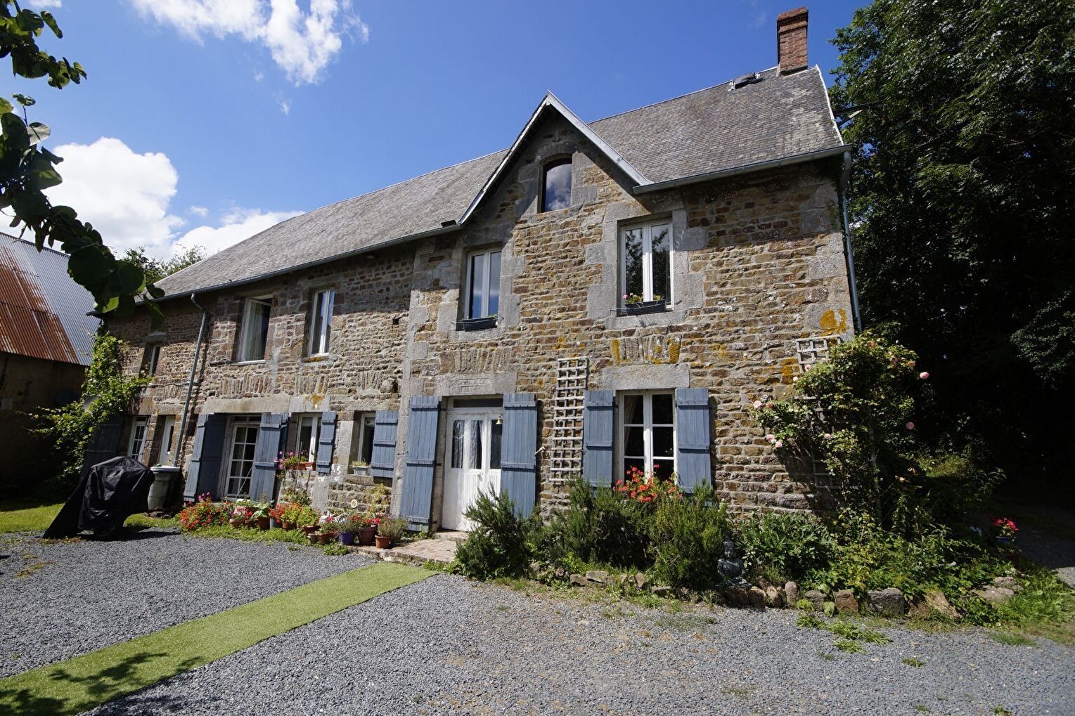 4-bedroom property in Manche, Normandy, featuring a stone façade and landscaped garden area.