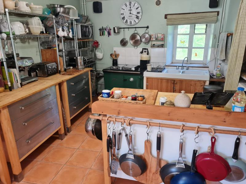 Spacious kitchen with wooden units and modern appliances in a property located in Manche, Normandy, 50450.