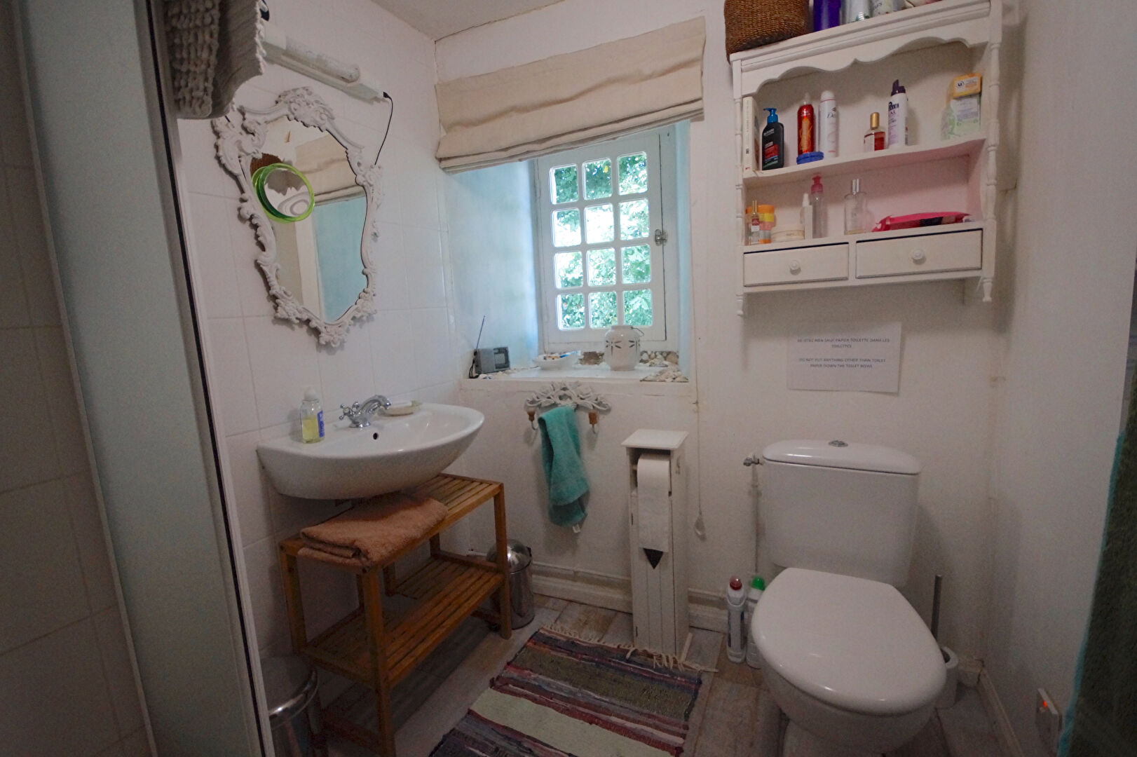Bathroom featuring a basin, toilet, and shelves, located in Manche, Normandy, with four bedrooms in the property.